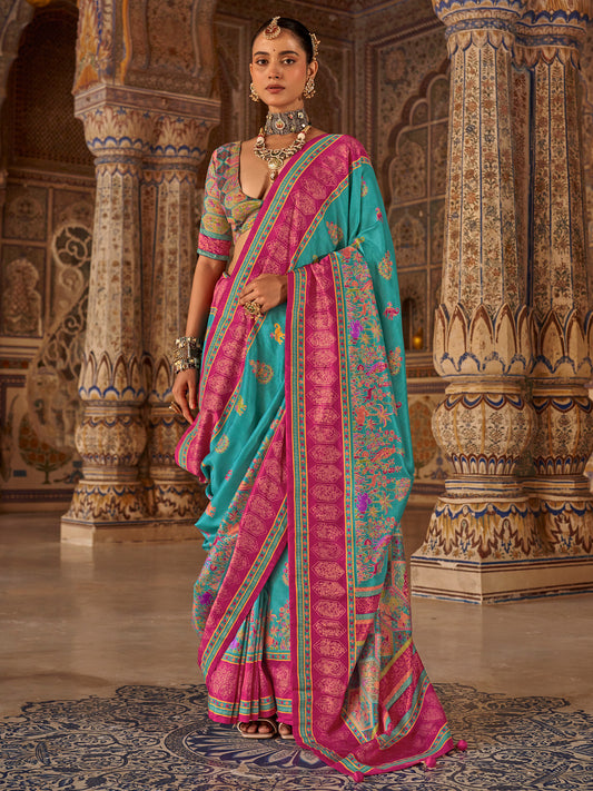 Woman wearing turquoise silk blend saree with traditional indian motif work and multicolored blouse