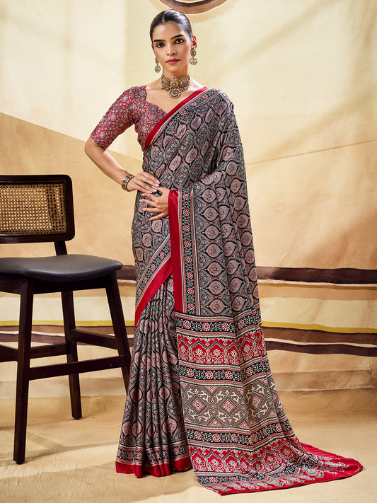 Woman wearing black satin saree with ajrak block-print motif work and maroon blouse