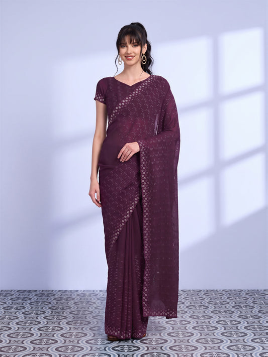 Woman wearing red tissue saree with ornamented surface design and red blouse