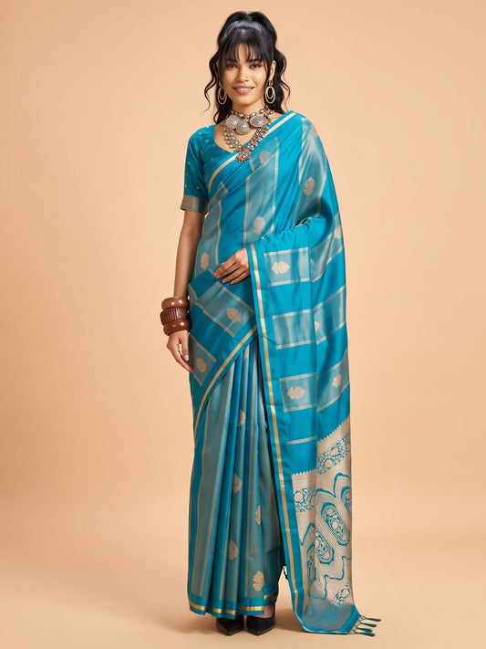 Woman wearing light blue satin saree with traditional indian motif work and light blue blouse