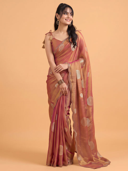 Woman wearing rust satin silk saree with metallic foil print work and rust blouse
