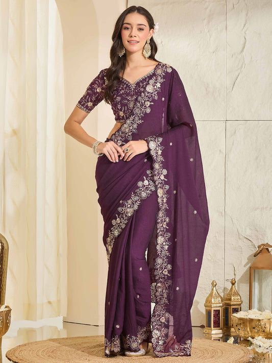 Woman wearing purple georgette saree with ornamented surface design and purple blouse