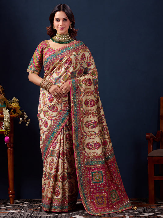 Woman wearing cream silk blend saree with traditional indian motif work and pink blouse