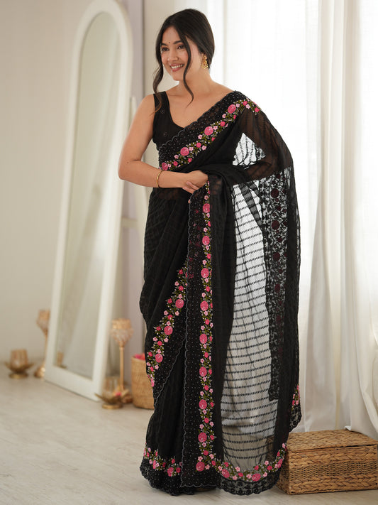 Woman wearing black georgette saree with ornamented surface design and black blouse