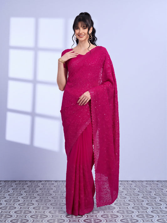 Woman wearing pink tissue saree with ornamented surface design and pink blouse