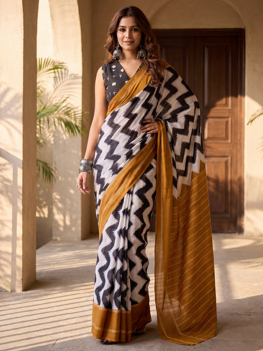 Woman wearing white cotton blend saree with chevron zigzag pattern and black blouse