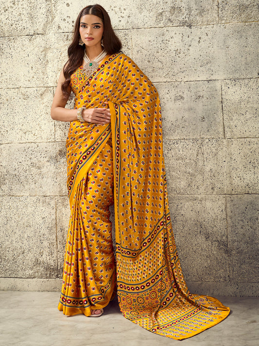 Woman wearing mustard satin saree with ajrak block-print motif work and mustard blouse