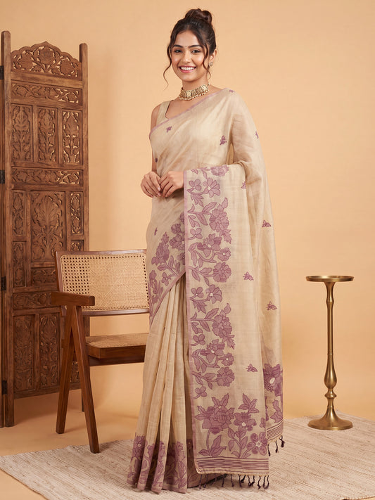Woman wearing cream chanderi cotton saree with all-over floral design and cream blouse