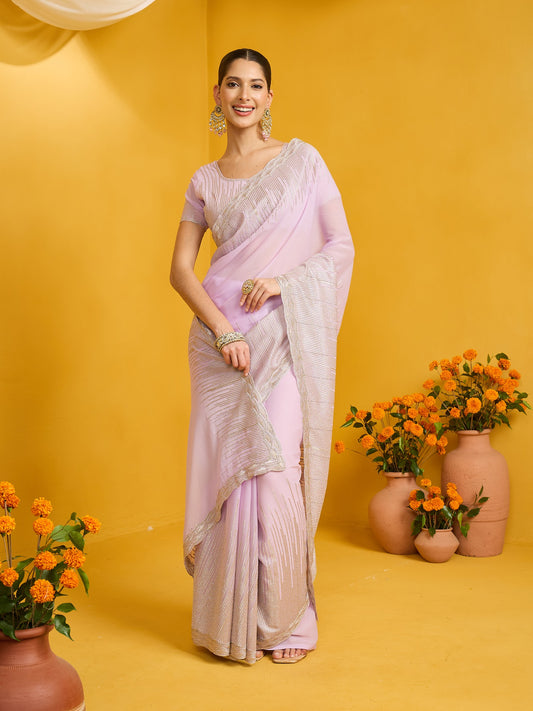 Woman wearing lavender pure georgette saree with embroidered motif work and lavender blouse
