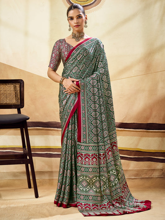 Woman wearing green satin saree with ajrak block-print motif work and maroon blouse