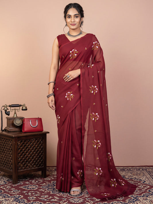 Woman wearing maroon kota doria cotton saree with embroidered motif work and maroon blouse
