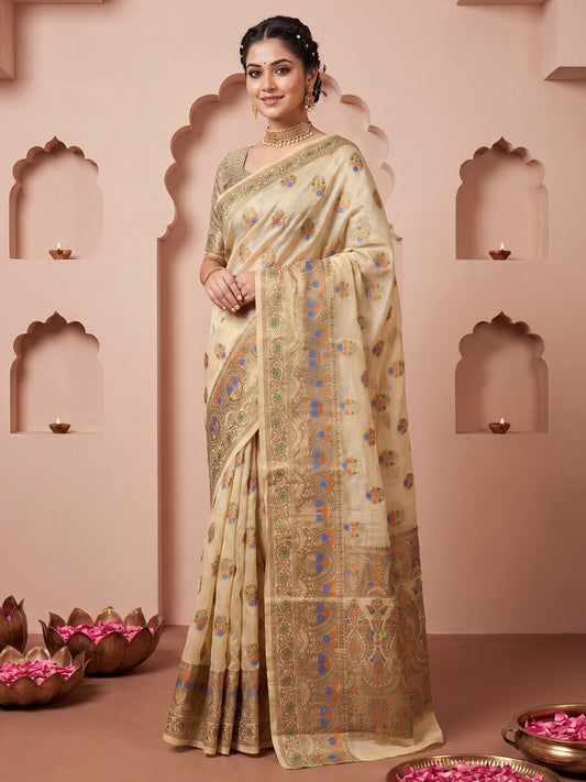 Woman wearing cream silk blend saree with zari butta (metallic motif) work and cream blouse