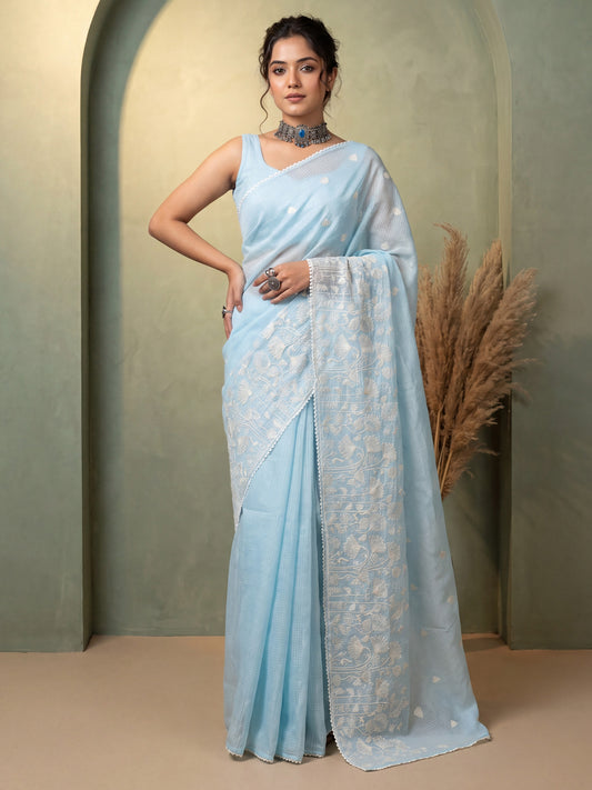 Woman wearing light blue kota doria cotton saree with embroidered motif work and light blue blouse