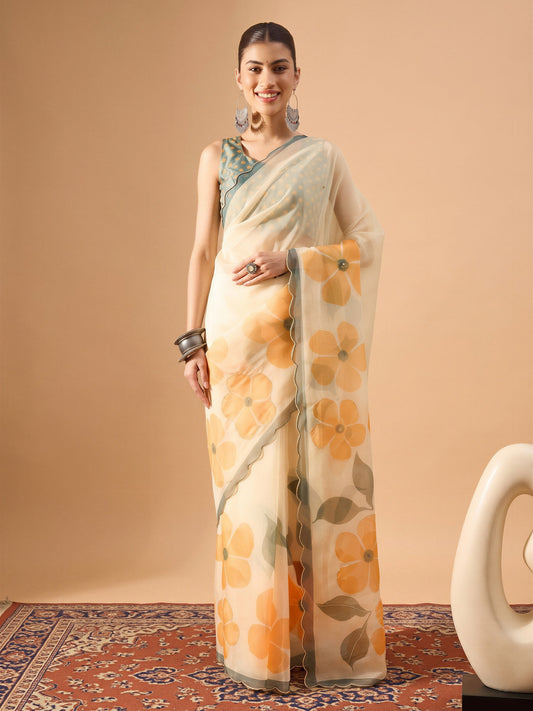 Woman wearing cream organza saree with all-over floral design and sea green blouse