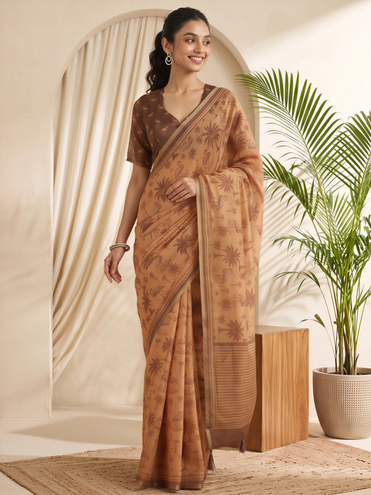 Woman wearing rust cotton linen saree with traditional indian motif work and brown blouse