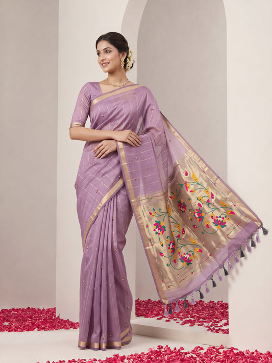 Woman wearing lavender silk blend saree with striped pattern design and lavender blouse