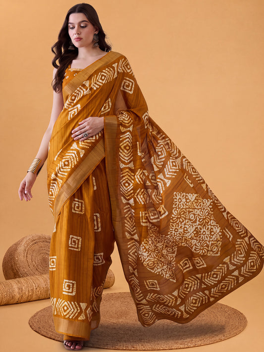 Woman wearing mustard silk blend saree with batik wax-resist design and mustard blouse