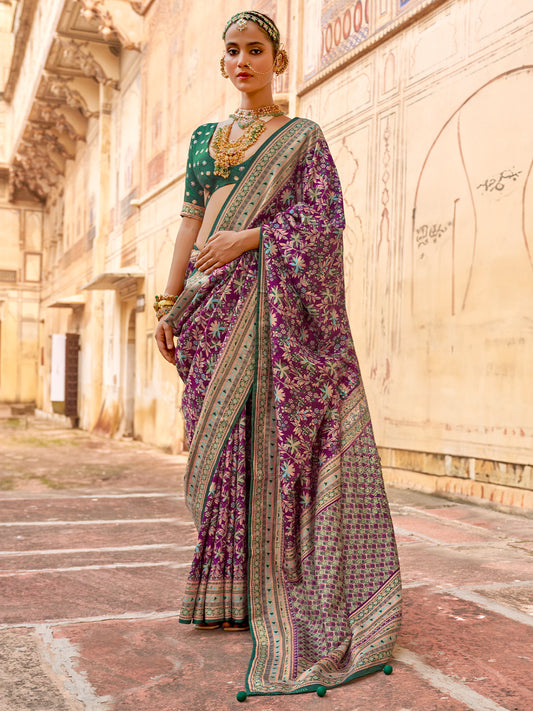 Woman wearing wine silk blend saree with kalamkari narrative motif work and green blouse