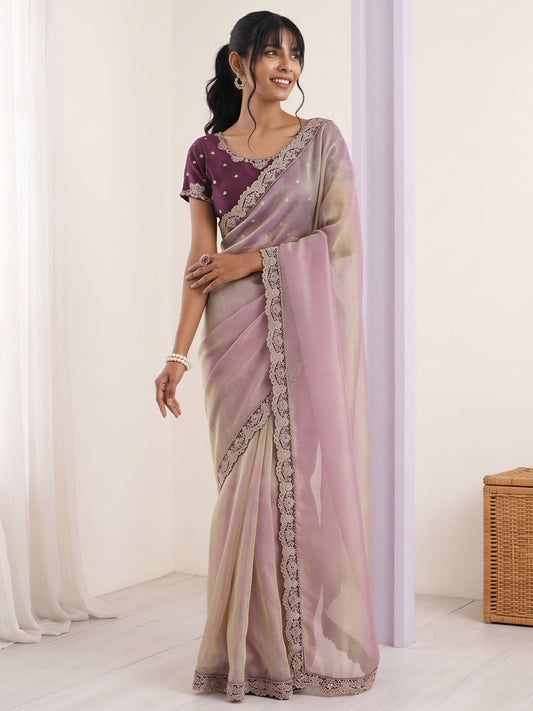 Woman wearing lavender net saree with embroidered motif work and purple blouse