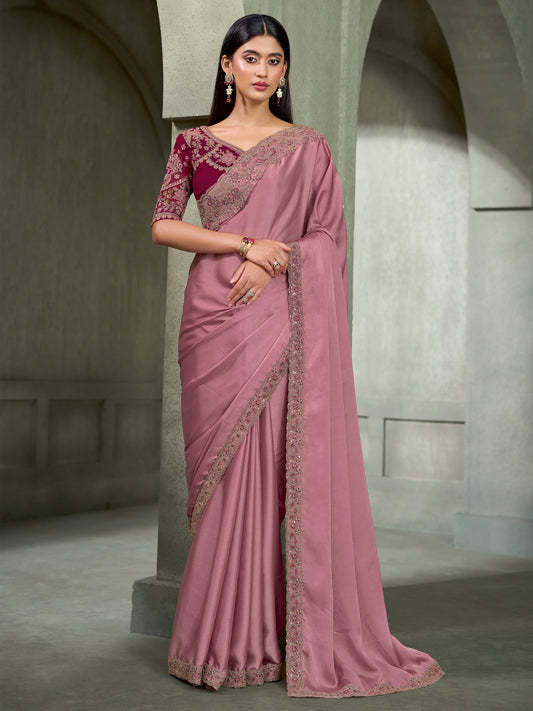 Woman wearing mauve georgette saree with embroidered motif work and magenta blouse