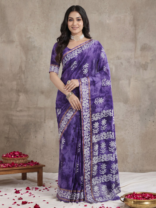 Woman wearing purple cotton saree with shibori resist-dye pattern and purple blouse