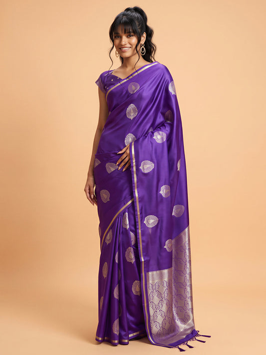 Woman wearing purple satin silk saree with zari butta (metallic motif) work and purple blouse