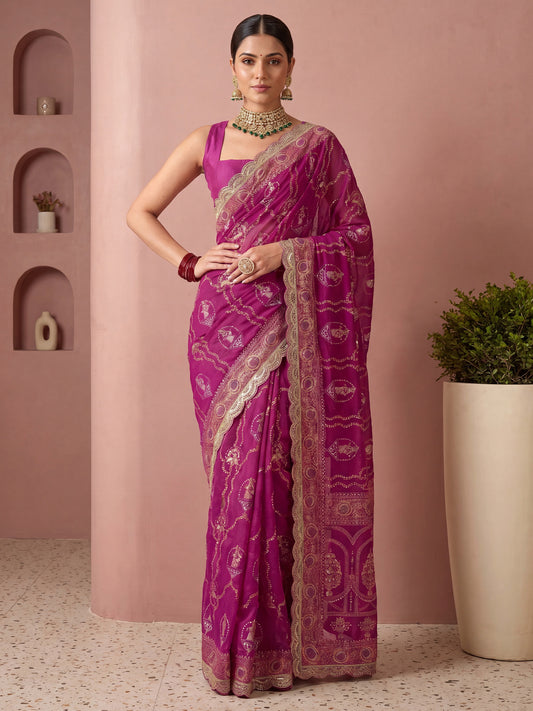 Woman wearing pink vichitra silk saree with metallic foil print work and pink blouse