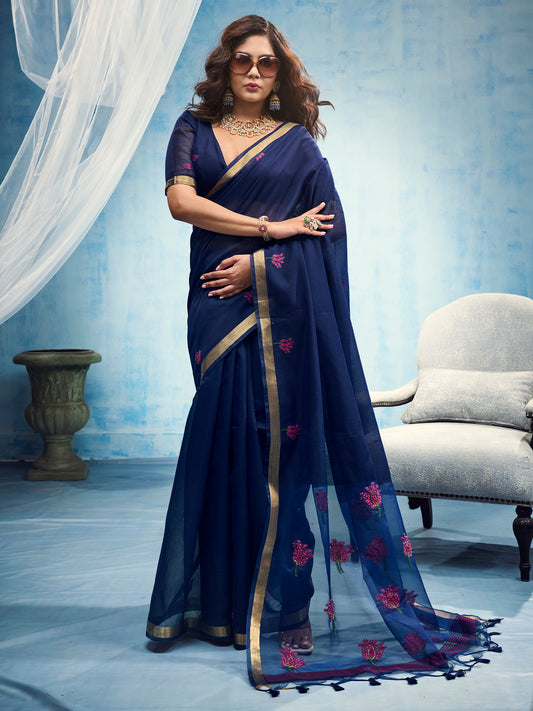 Woman wearing blue muga cotton saree with embroidered motif work and blue blouse