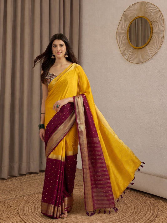 Woman wearing mustard mysore silk saree with zari butta (metallic motif) work and black blouse