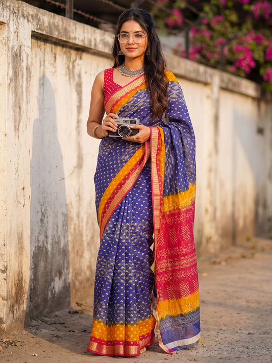 Woman wearing blue cotton saree with bandhani tie-dye dot work and pink blouse
