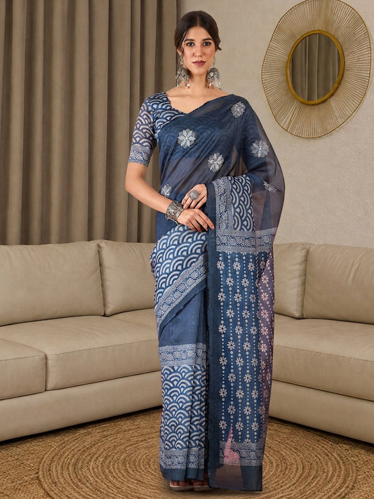 Woman wearing blue silk blend saree with all-over floral design and blue blouse