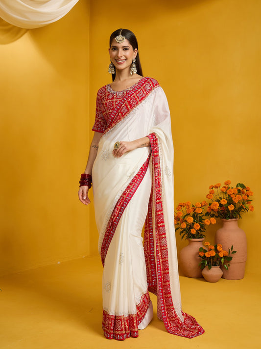 Woman wearing white silk blend saree with ornamented surface design and red blouse