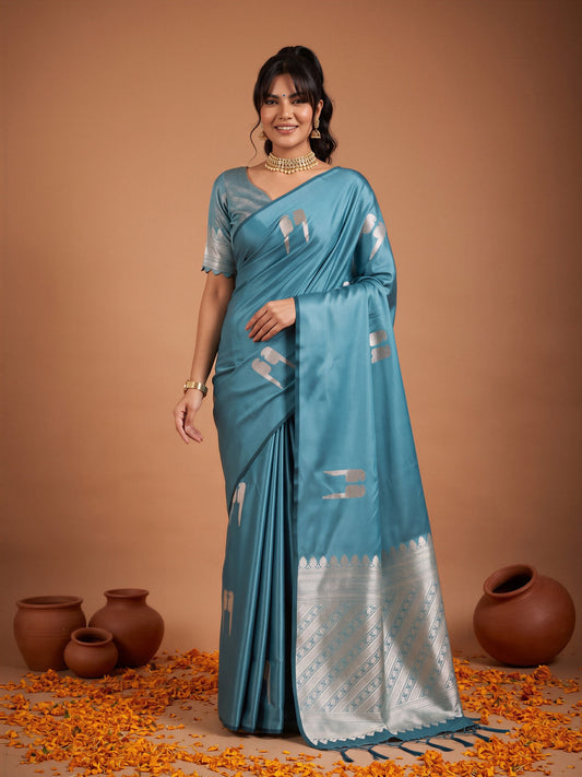 Woman wearing light blue satin saree with botanical floral and leaf design and light blue blouse