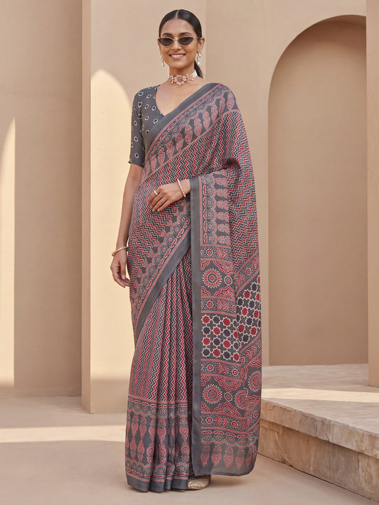 Woman wearing grey satin saree with geometric pattern design and grey blouse