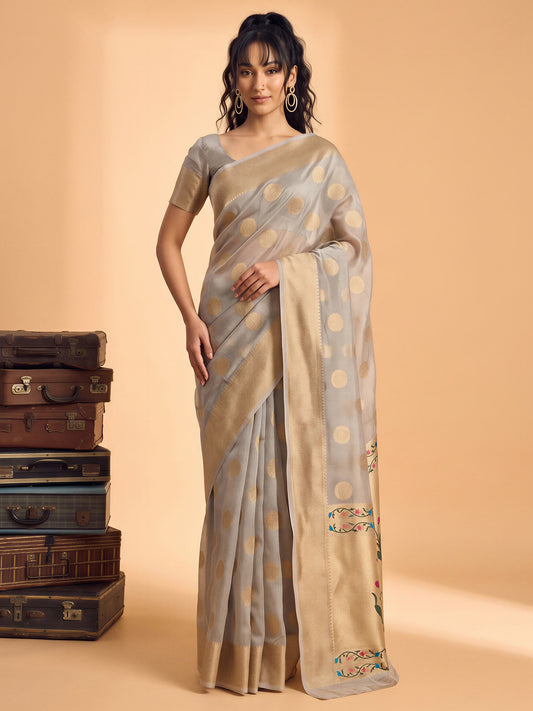 Woman wearing grey tissue saree with zari butta (metallic motif) work and grey blouse