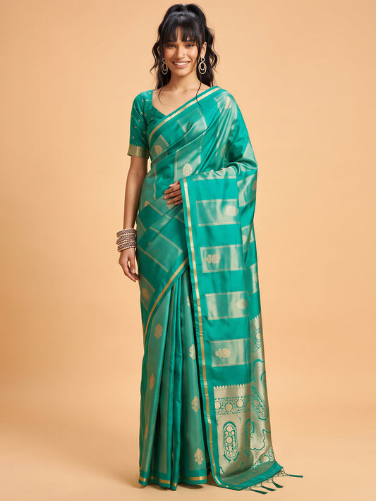 Woman wearing teal green satin saree with traditional indian motif work and teal green blouse