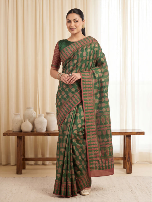 Woman wearing green silk blend saree with ajrak block-print motif work and green blouse