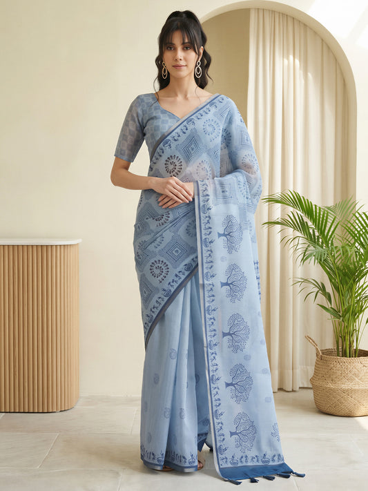 Woman wearing light blue cotton linen saree with warli folk-art figures and light blue blouse