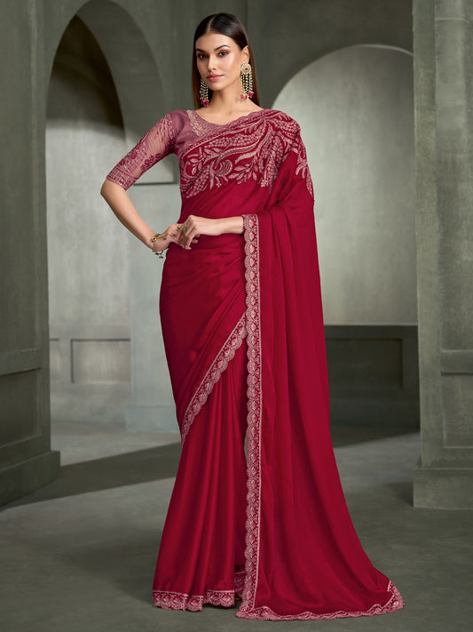Woman wearing red satin silk saree with embroidered motif work and mauve blouse