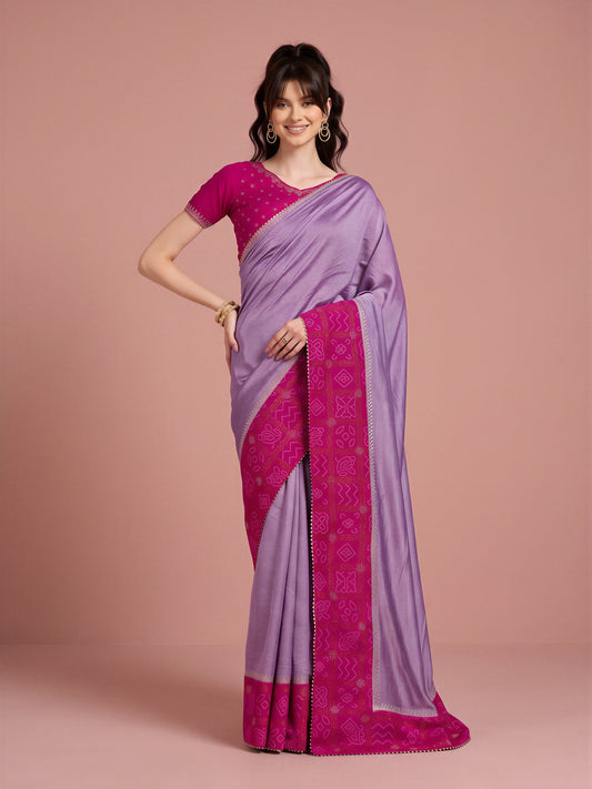 Woman wearing lavender vichitra silk saree with bandhani tie-dye dot work and pink blouse