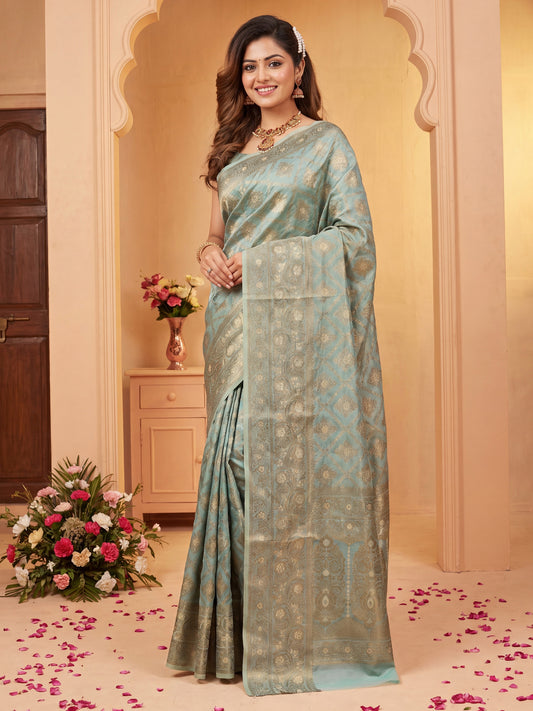 Woman wearing light blue silk blend saree with traditional indian motif work and light blue blouse