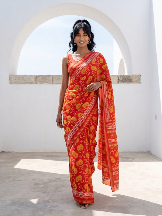 Woman wearing orange crepe saree with botanical floral and leaf design and orange blouse