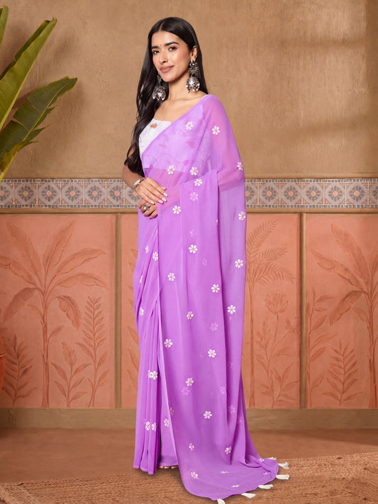 Woman wearing lavender georgette saree with embroidered motif work and white blouse