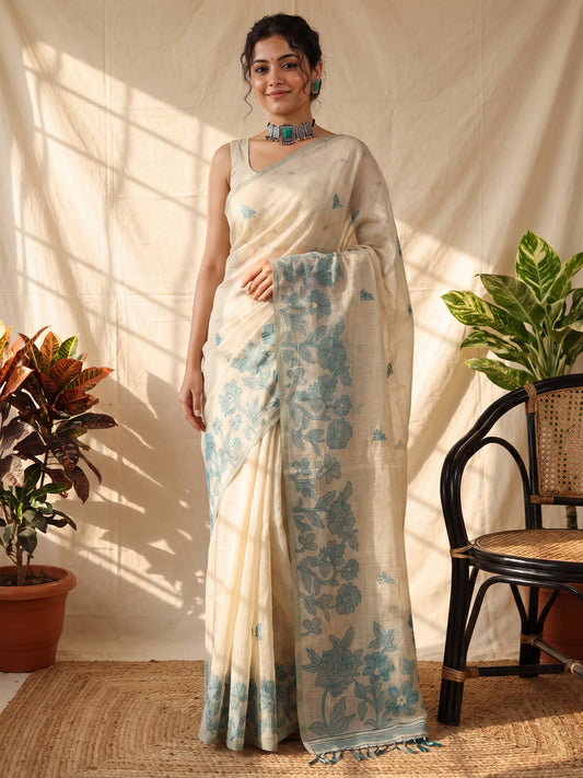 Woman wearing cream chanderi cotton saree with all-over floral design and cream blouse