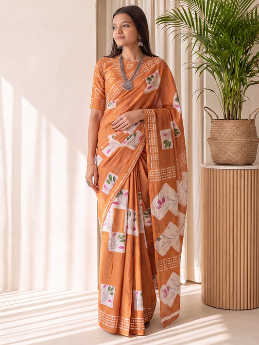 Woman wearing orange cotton saree with traditional indian motif work and orange blouse