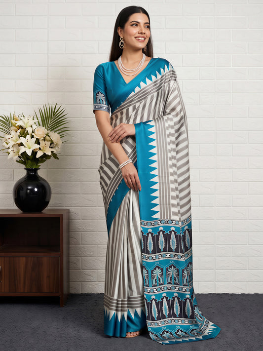 Woman wearing teal blue satin saree with striped pattern design and teal blue blouse