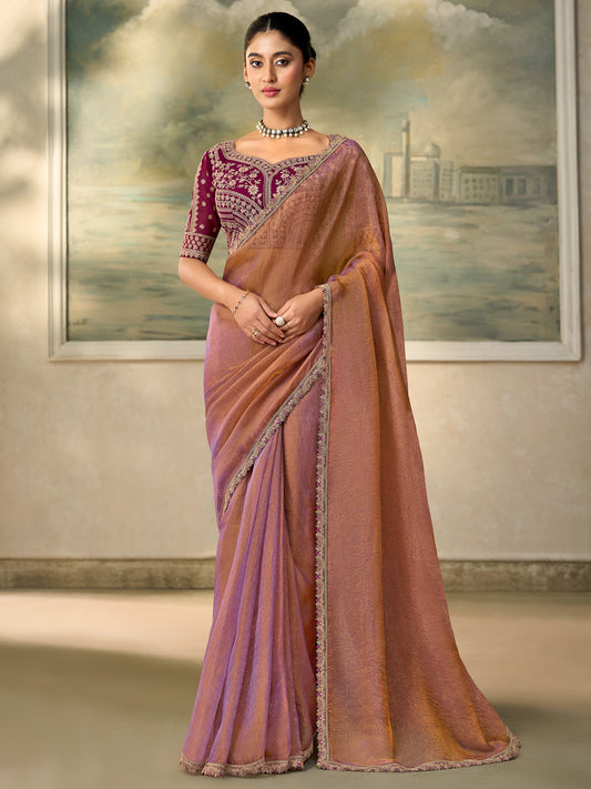 Woman wearing rose gold georgette saree with embroidered motif work and wine blouse