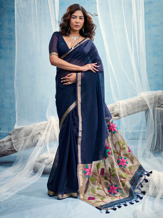 Woman wearing navy blue muga silk saree with clean solid-tone finish and navy blue blouse