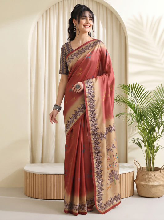 Woman wearing rust silk blend saree with peacock motif design and cream blouse