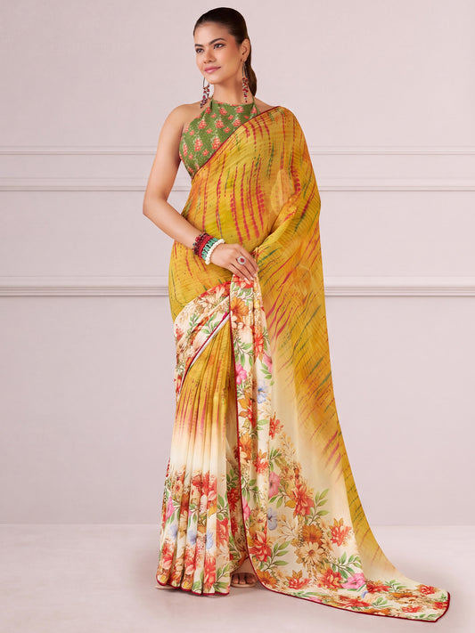 Woman wearing mustard georgette saree with all-over floral design and green blouse